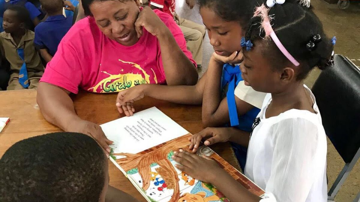 A group of children reading a book together